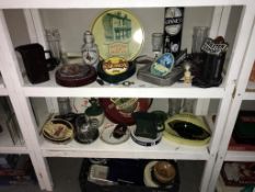 A quantity of breweriana on 3 shelves including ashtrays,