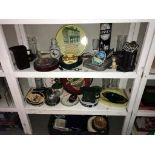 A quantity of breweriana on 3 shelves including ashtrays,