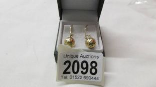 A pair of 9ct gold golf ball design earrings.