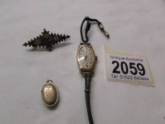 A vintage gold wrist watch, a micromosaic brooch and a yellow metal pendant.