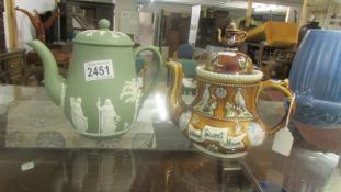 A Wedgwood green Jasper ware teapot and a pottery barge teapot.