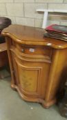 An inlaid cabinet with domed front, faded.