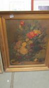 A large gilt framed oil on canvas floral study, signed. Needs a good clean.