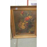 A large gilt framed oil on canvas floral study, signed. Needs a good clean.