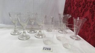 Three glass measures, 4 liquor glasses and 3 small fine glass tumblers.