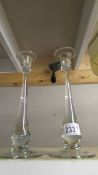 A pair of designer glass candlesticks.