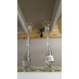 A pair of designer glass candlesticks.