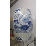 A large blue and white ceramic garden stool.