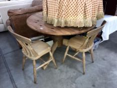 A large round solid pine kitchen table and 2 chairs