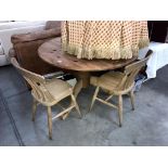 A large round solid pine kitchen table and 2 chairs