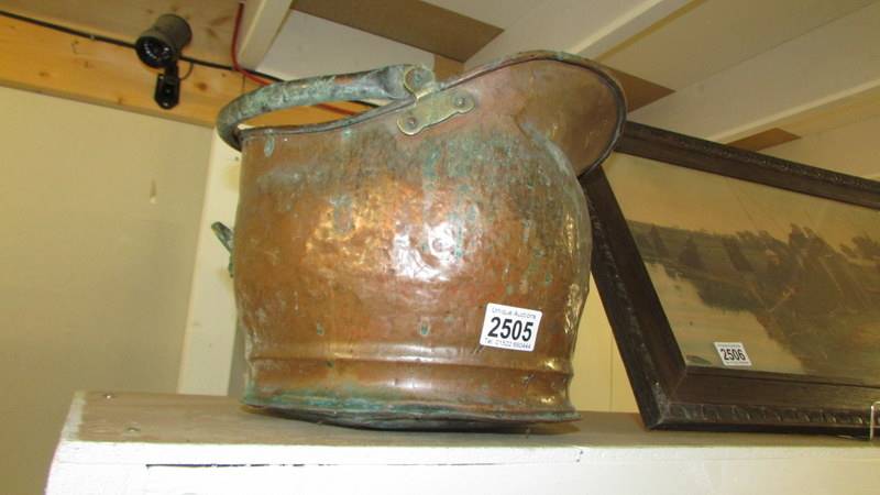 An old copper coal scuttle.