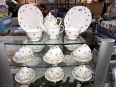 A china tea set with red roses design,