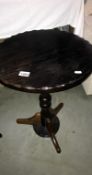 A round oak topped side table with turned mahogany column