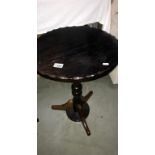 A round oak topped side table with turned mahogany column