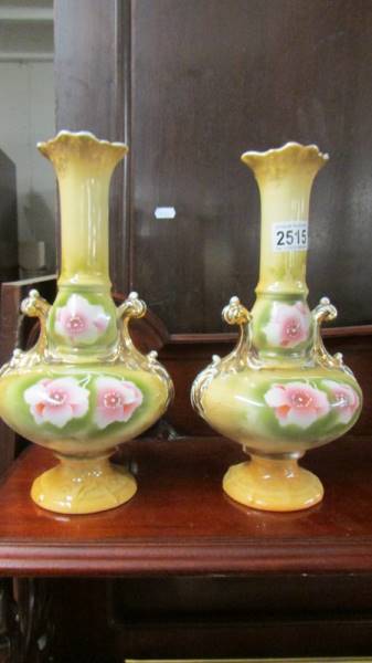 A pair of Staffordshire floral decorated vases.