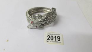 A Butler and Wilson crocodile bangle.