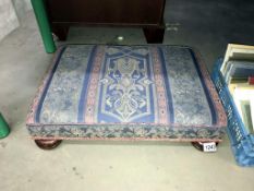 A tapestry covered footstool