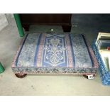 A tapestry covered footstool