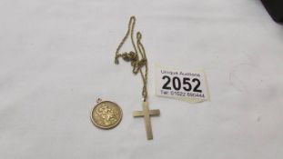 A 9ct gold St. Christopher and a 9ct gold cross on an unmarked chain.