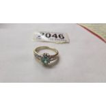 A yellow gold oval emerald and diamond ring, size M half.