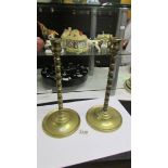 A pair of tall brass candlesticks, 32cm.