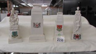 Four assorted crested war monuments.