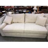 A cream fabric covered single end sofa