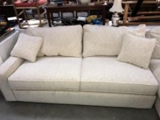 A cream fabric covered single end sofa