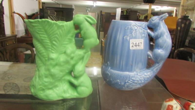 A blue Sylvac squirrel jug and a green Sylvac rabbit jug.