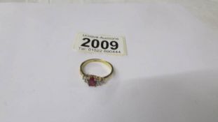 A 9ct gold ring set red and white stones, size S.