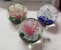 Three good quality glass paperweights.