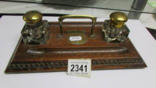 An early 20th century inkstand with glass inkwells.