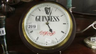 A Guiness advertising wall clock.