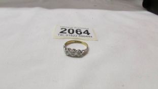 An 18ct gold and platinum three stone diamond ring set in heart mounts, size L half. 3 grams.