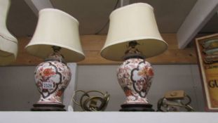 A pair of Imari style table lamps with silk shades,