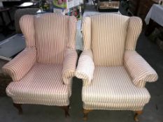 A pair of pink and cream stripped arm chairs