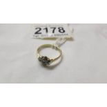 A gold ring set four stones, size L, hall marked rubs. 2 grams.