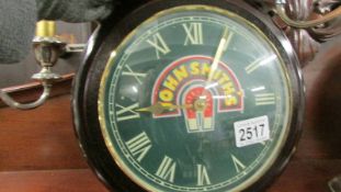 A John Smith's advertising wall clock.