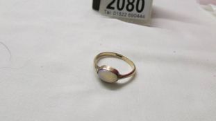 A 19th century 9ct gold opal ring in an oval setting, size O.