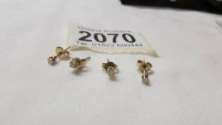 Two pairs of yellow metal stud earrings, test as 9ct. 1 gram.