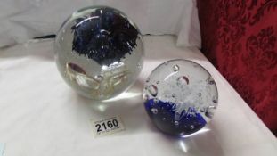 A large glass paperweight and one other.