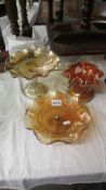 A marigold butterfly & wreath cake stand (Australian), another cake stand and a vase.