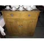 An antique pine kitchen cupboard with drawers