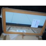 A new and boxed Ercol mirror, 100 x 60 cm.