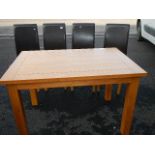 A good clean oak table and a set of 4 faux leather chairs.