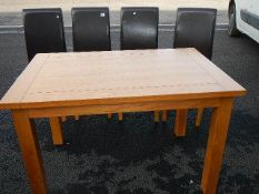 A good clean oak table and a set of 4 faux leather chairs.
