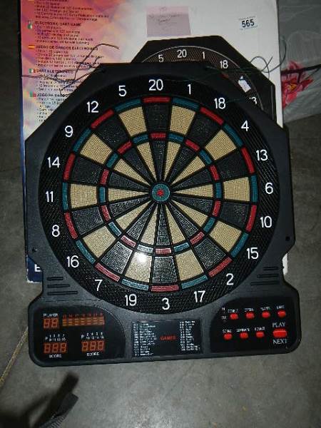 A digital electronic dart board complete with darts and instructions and a 9 volt DC adaptor.