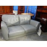 A grey leather 2 seat sofa in good condition.