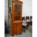 A mahogany effect corner cabinet.