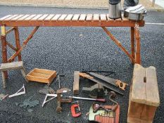 A wooden shelf/stand, wooden stools, tools etc.